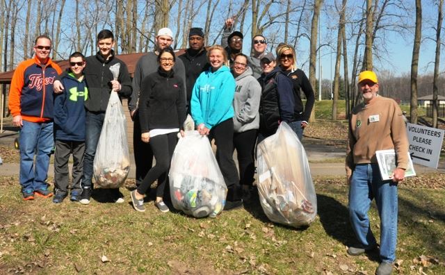 Helpers showing off how much trash was picked up